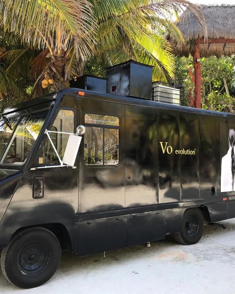 The Beauty Truck parked beside a palapa